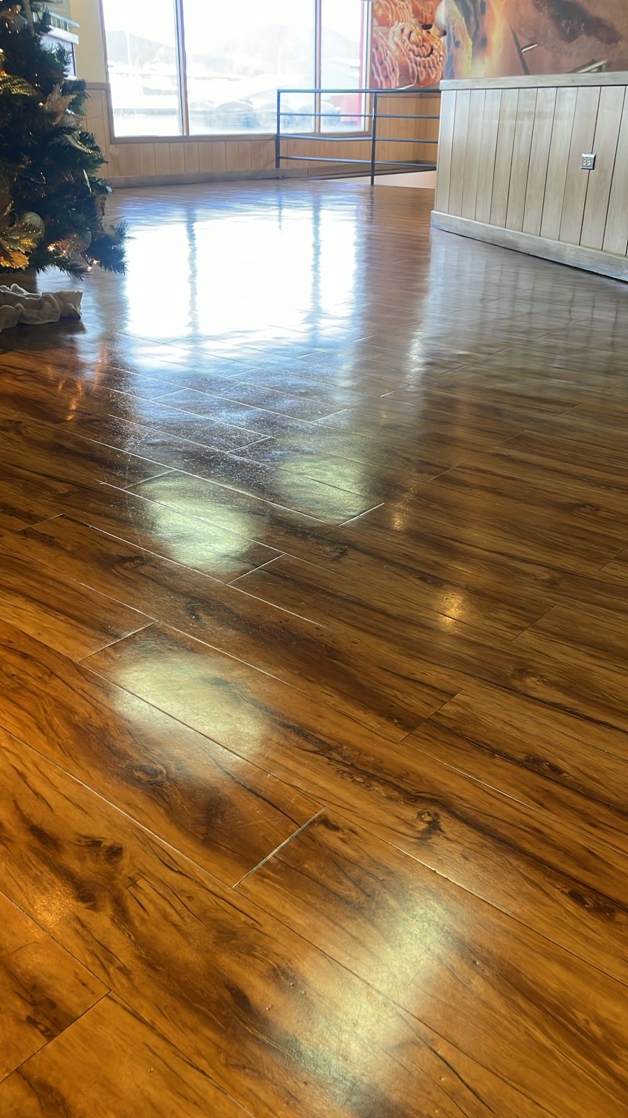 High gloss wood look floor in a commercial dining area after stripping and polishing